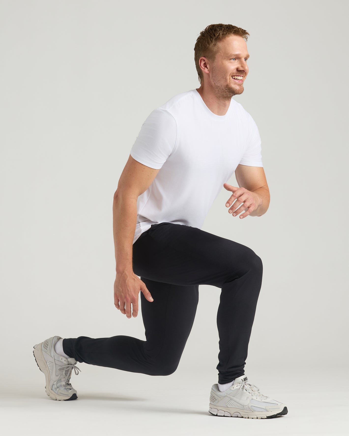 Man lunging in Black & Charcoal Heather Gray Tall Active Joggers.