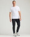Man modeling Black Tall Active Joggers with white T-shirt and Nike shoes.