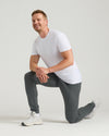 Man wearing Charcoal Heather Gray Tall Active Joggers, kneeling, showcasing slim fit.