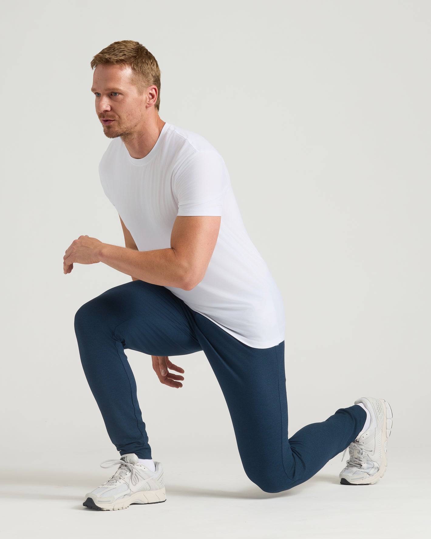 Man in Dark Heather Navy Tall Active Joggers, ready to sprint.