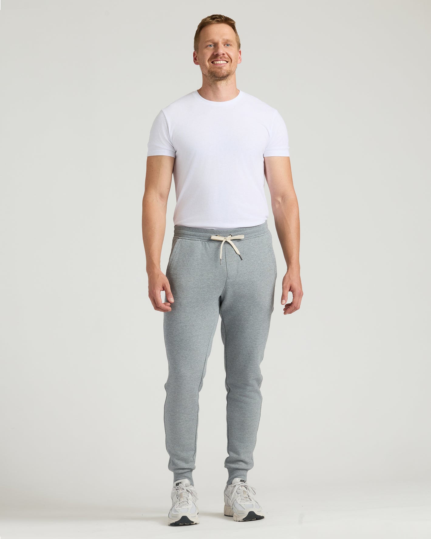 Man wearing Tall Fleece French Terry Joggers, showcasing comfy, tailored fit.