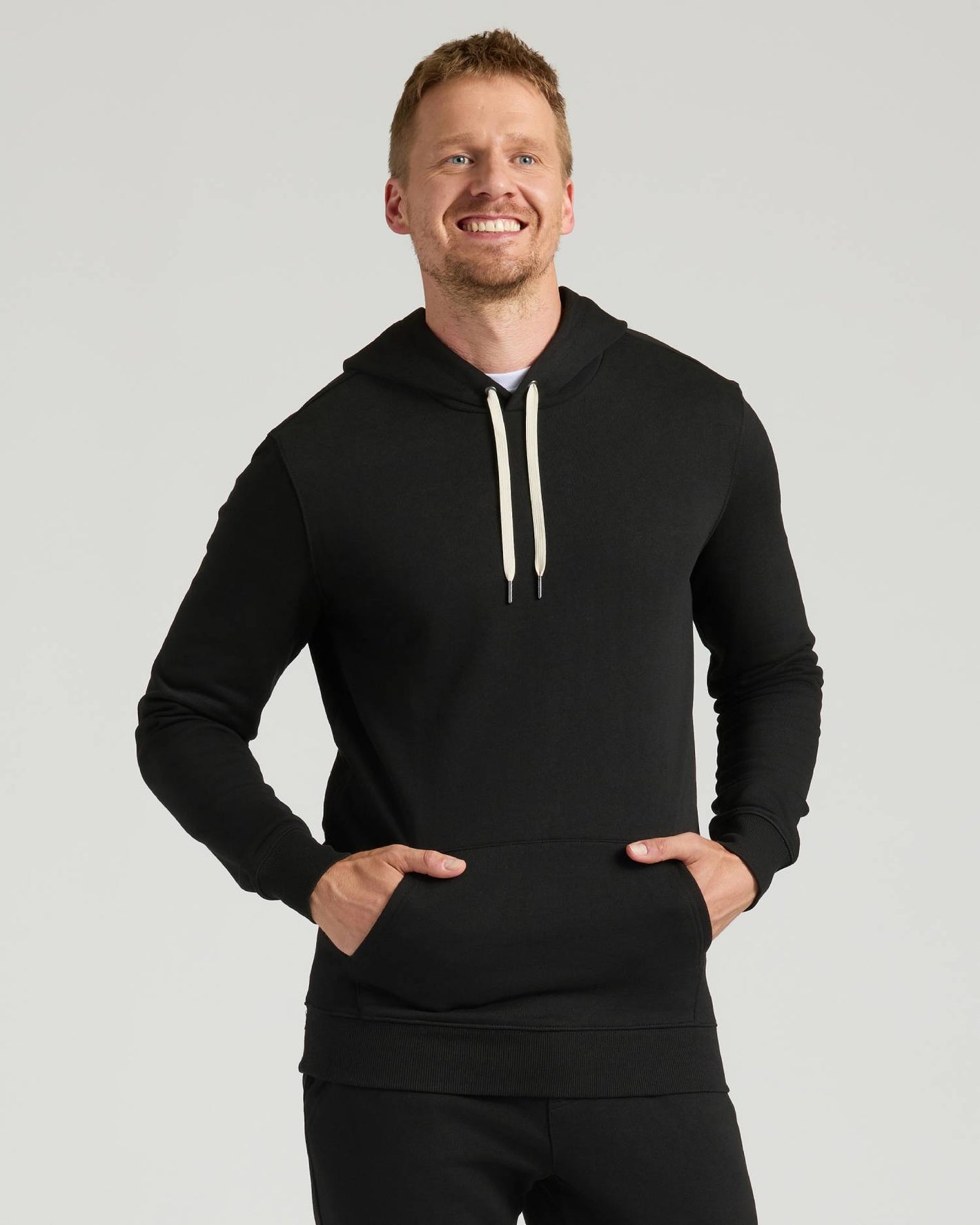 Man wearing Black Tall Fleece Pullover Hoodie from 2-Pack.