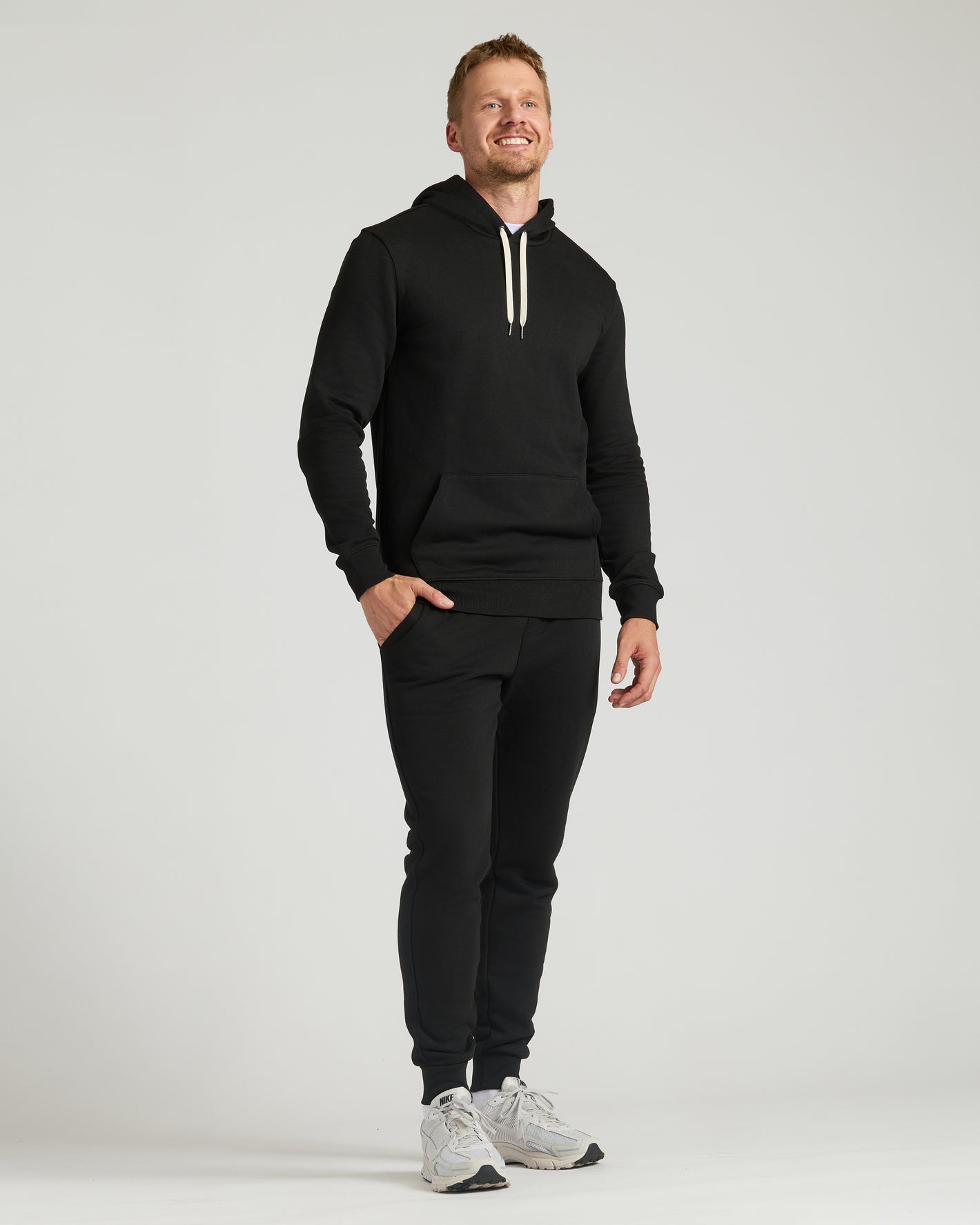 Man wearing Black Tall Fleece French Terry Pullover Hoodie.