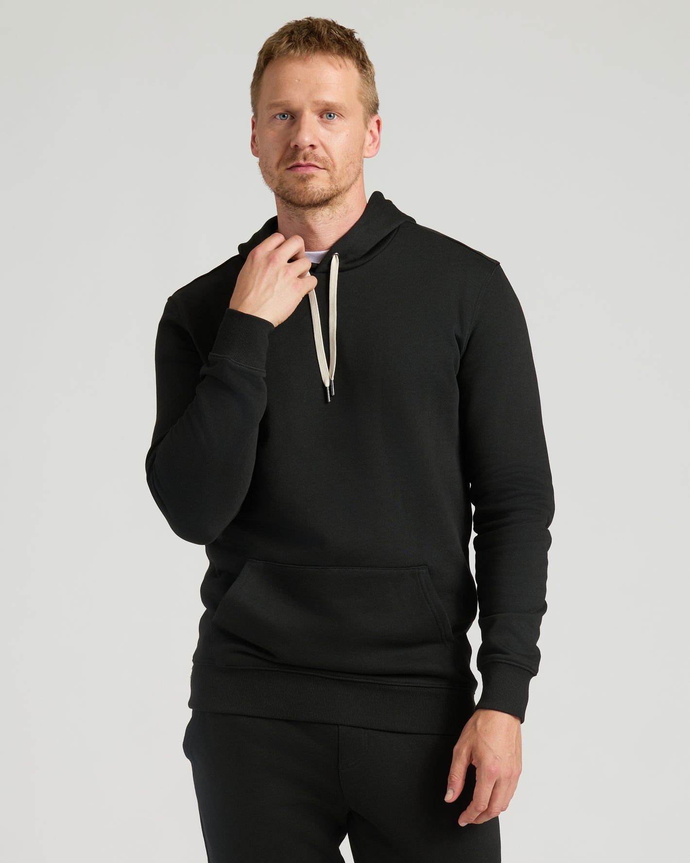 Black Tall Fleece French Terry Pullover Hoodie on male model, relaxed fit.