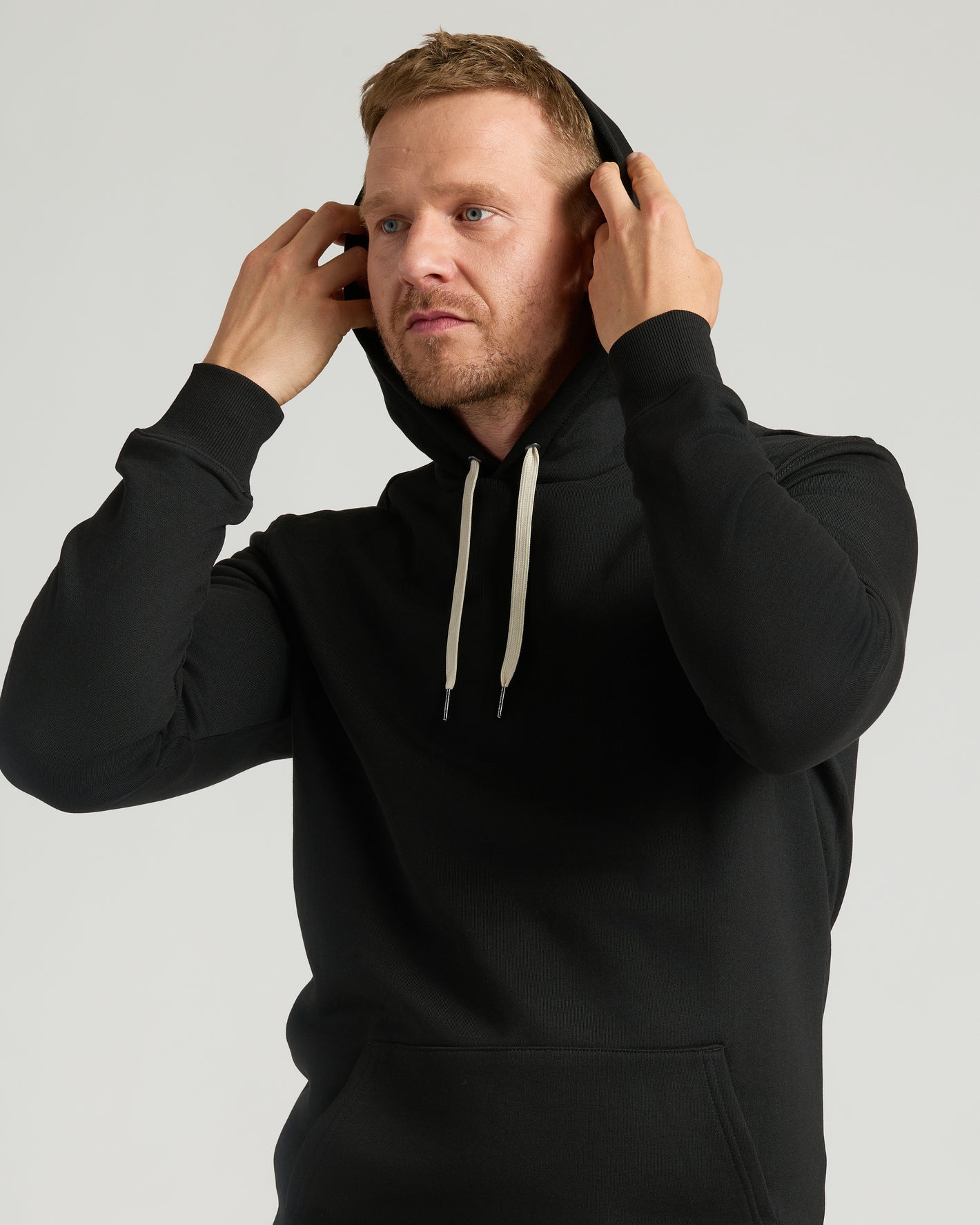 Man wearing Black Tall Fleece French Terry Pullover Hoodie.