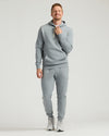 Man wearing Medium Heather Gray Tall Fleece Pullover Hoodie & Joggers 2-Pack.