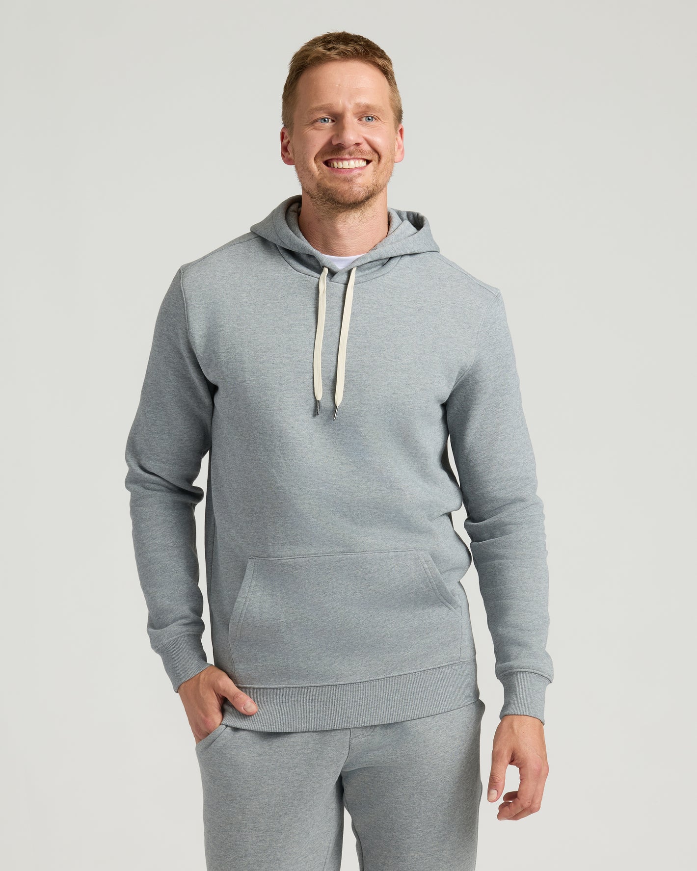 Medium Heather Gray Tall Fleece French Terry Pullover Hoodie on smiling man.