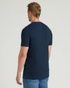 Man wearing a navy blue t-shirt on a light gray background