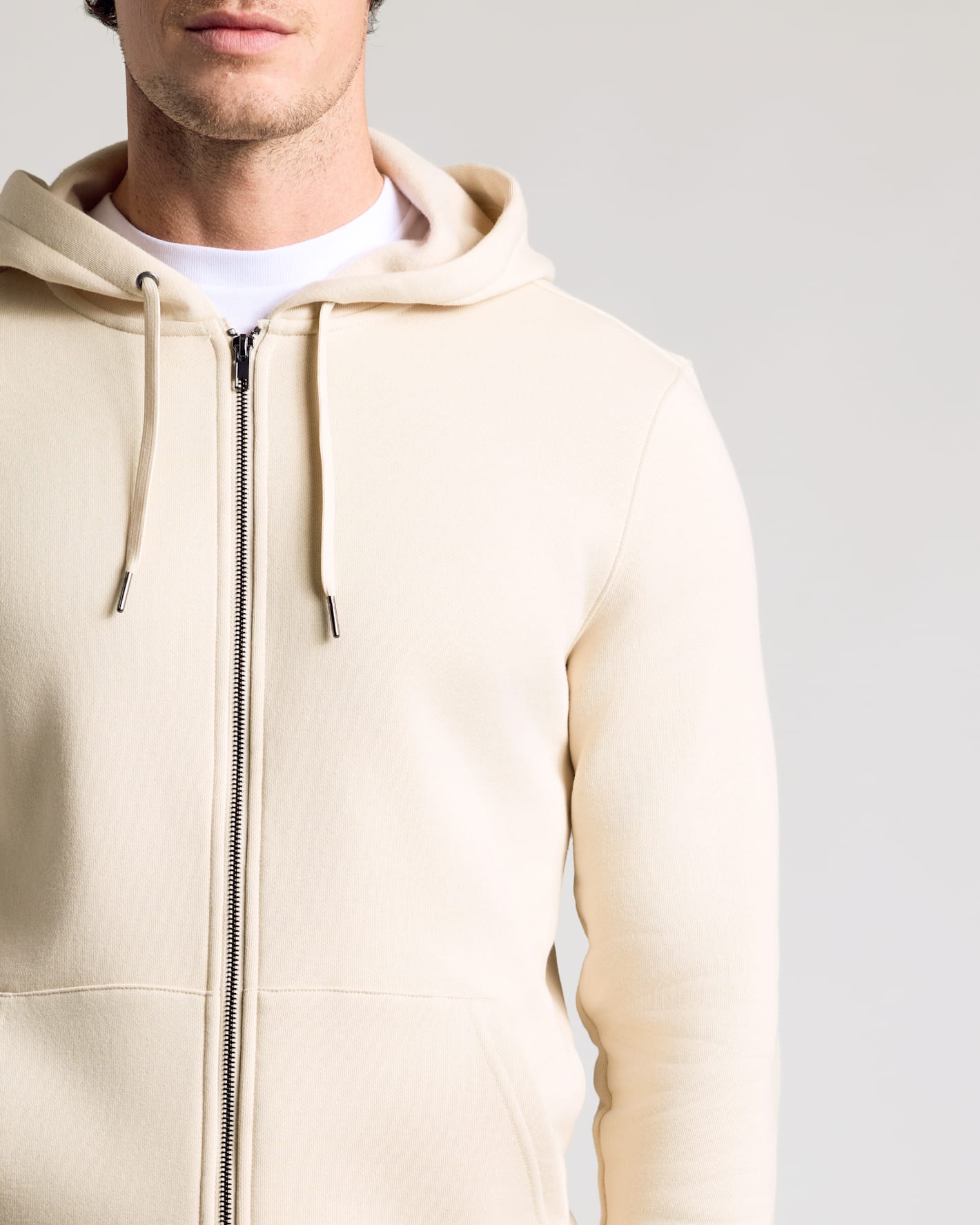 Man wearing the Dune Fleece French Terry Zip Hoodie.