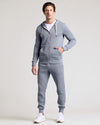 Man models Dusty Blue Fleece French Terry Zip Hoodie, hands in pocket.
