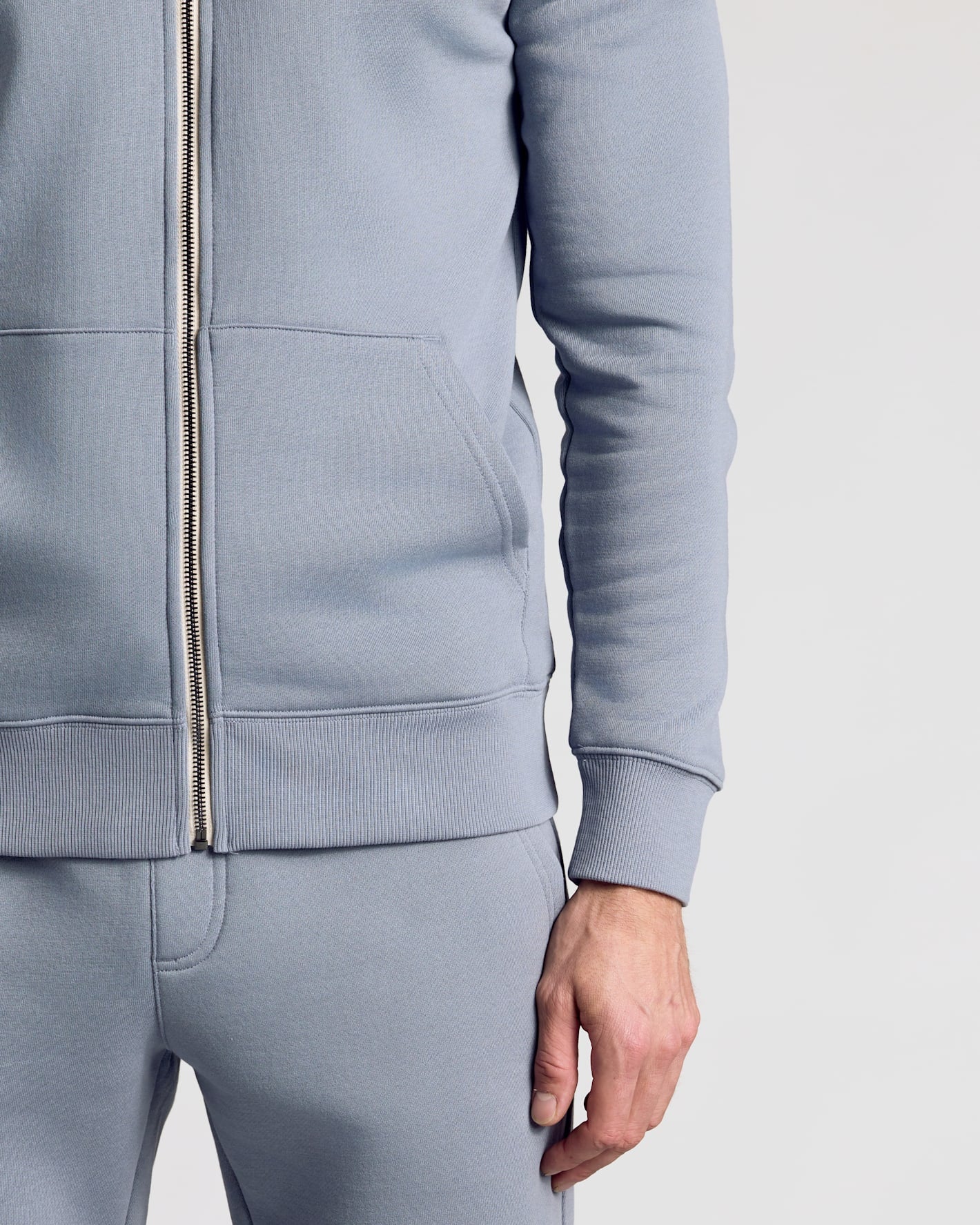 Wearing Dusty Blue Fleece French Terry Zip Hoodie with matching sweatpants.