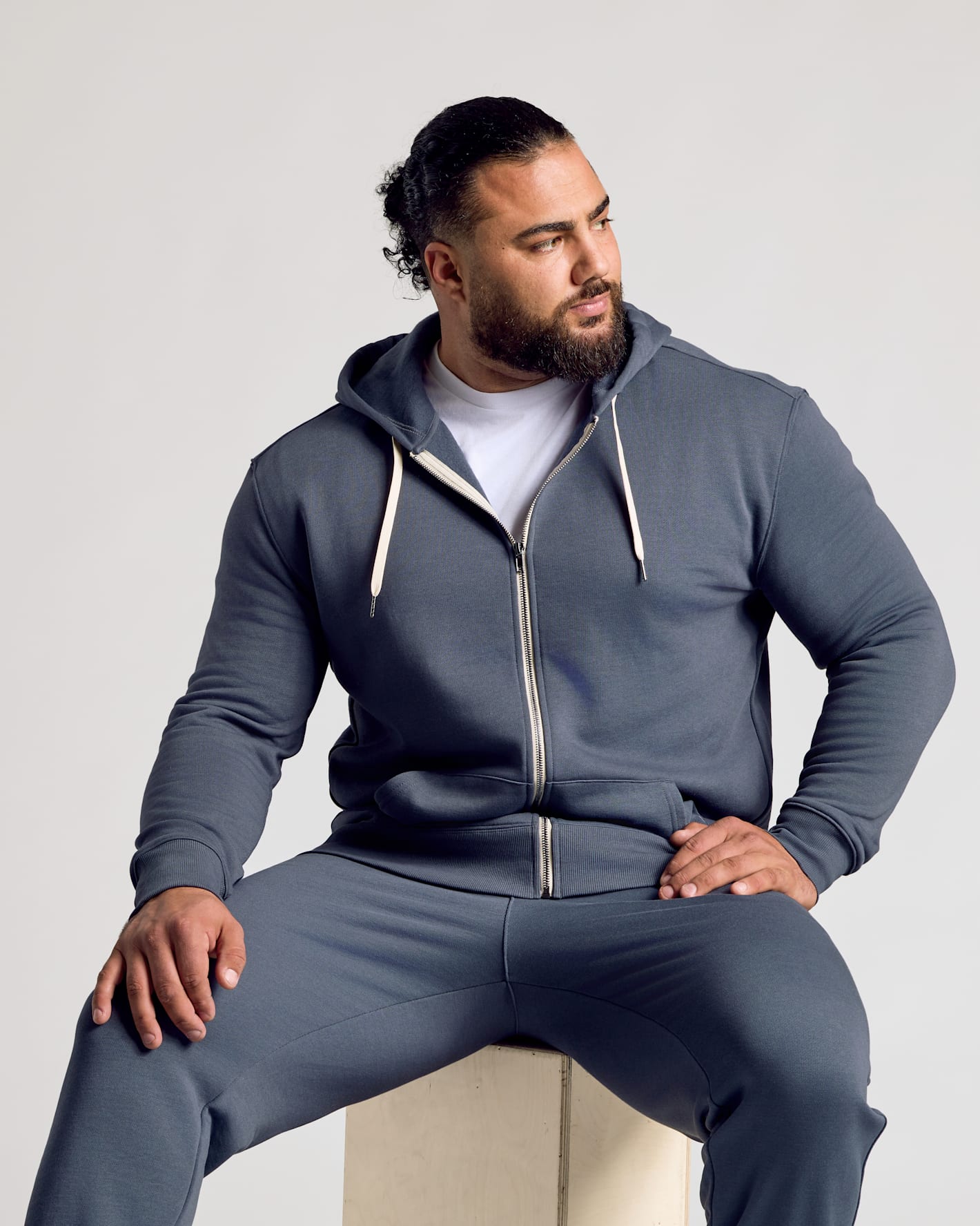 Stormy Full Zip Fleece Hoodie & Jogger 2-Pack worn by a seated man.