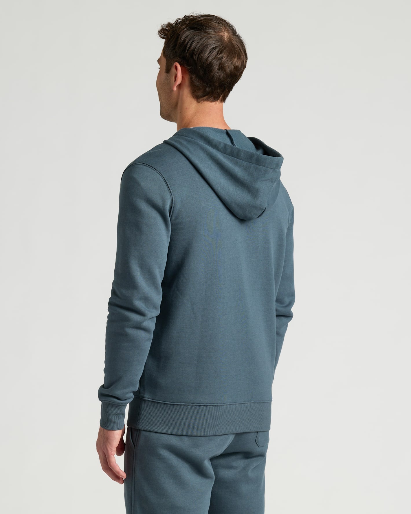 Man wearing Neptune Fleece French Terry Pullover Hoodie from behind.