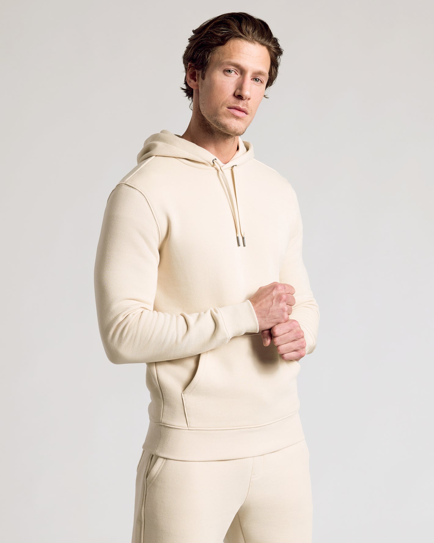 Man wearing Dune Fleece French Terry Pullover Hoodie and matching joggers.