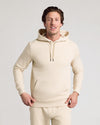 Man in Dune Fleece French Terry Pullover Hoodie, hands on hem.