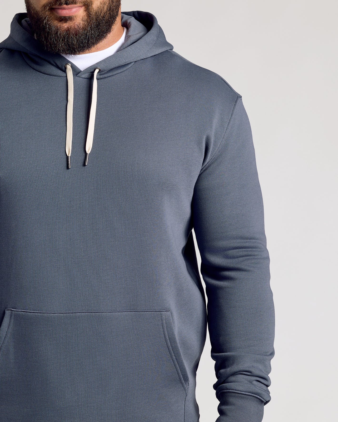 Man wearing Stormy Fleece French Terry Pullover Hoodie with pocket.