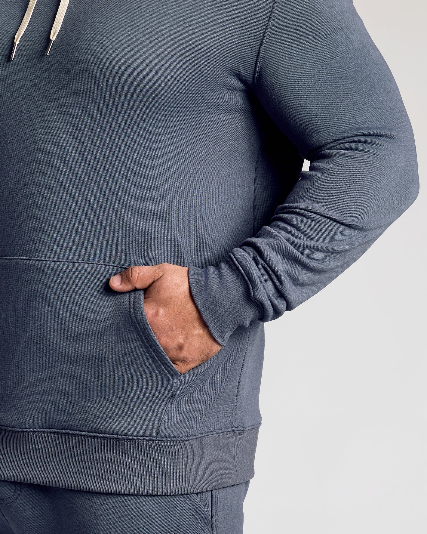 Wearing Stormy Fleece French Terry Pullover Hoodie with kangaroo pocket.