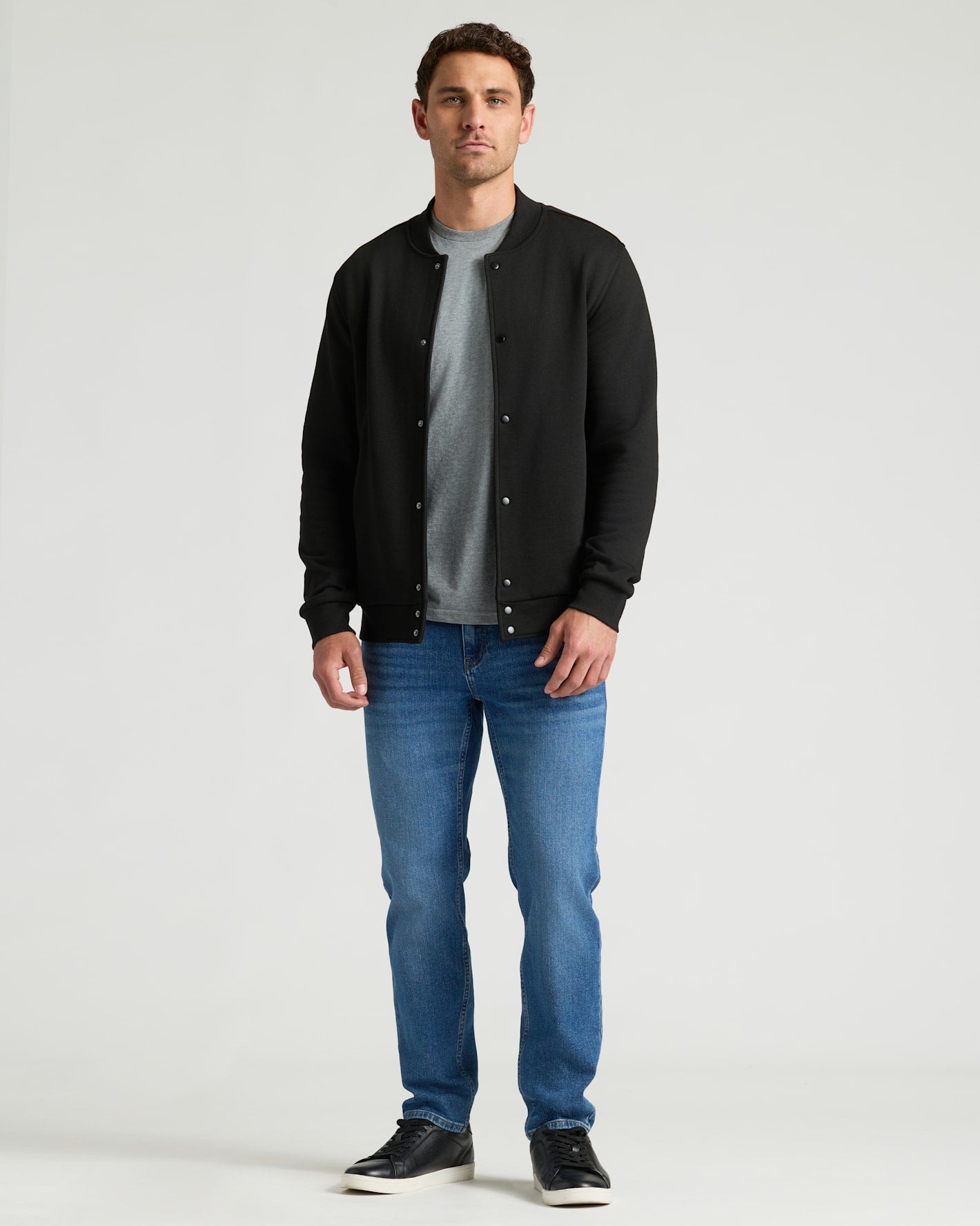 Black Fleece Bomber Jacket worn casually with jeans and sneakers.