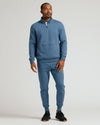 Man modeling Fiord Half Zip Fleece Sweatshirt with joggers and athletic shoes.