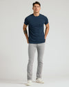 Medium Gray Wash Slim Comfort Stretch Jeans on model with navy T-shirt.