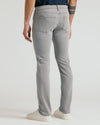 Medium Gray Wash Slim Comfort Stretch Jeans with white sneakers visible.