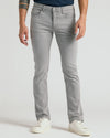 Medium Gray Wash Slim Comfort Stretch Jeans with white sneakers modeled.