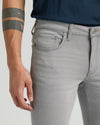 Medium Gray Wash Slim Comfort Stretch Jeans with visible waistband and tattoos.