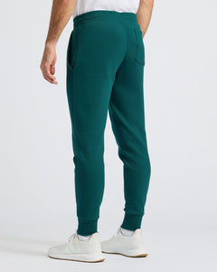 True ClassicDeep Emerald Fleece French Terry Joggers with sneakers, showcasing comfort fit.