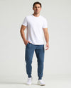 Man wearing Fiord Fleece French Terry Joggers with white T-shirt.