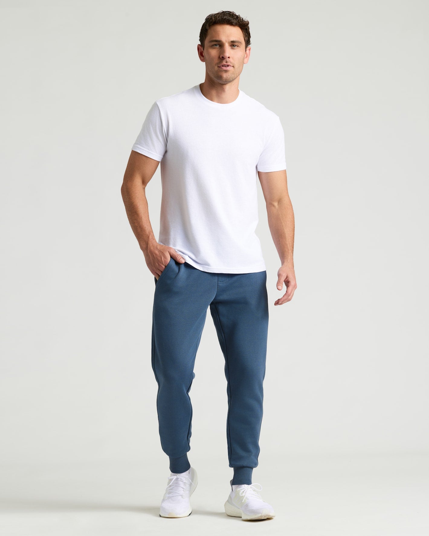Man wearing Fiord Fleece French Terry Joggers with white T-shirt.