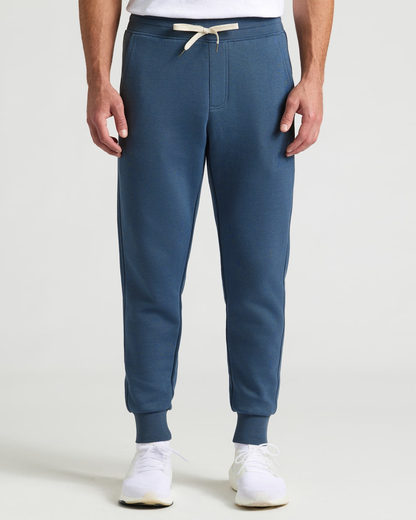 Fiord Fleece French Terry Joggers with cuffed ankles and white sneakers.