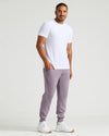 Man wearing Thistle Fleece French Terry Joggers with a white T-shirt.