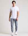 Man wearing Dusty Blue Fleece French Terry Joggers with white T-shirt and sneakers.