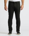 Person wearing black jeans on a white background