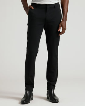 Black Commuter Pants with slim fit, worn with black Chelsea boots.
