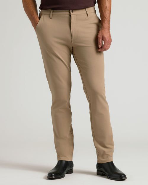 Khaki Commuter Pants with black Chelsea boots, hands in pockets.