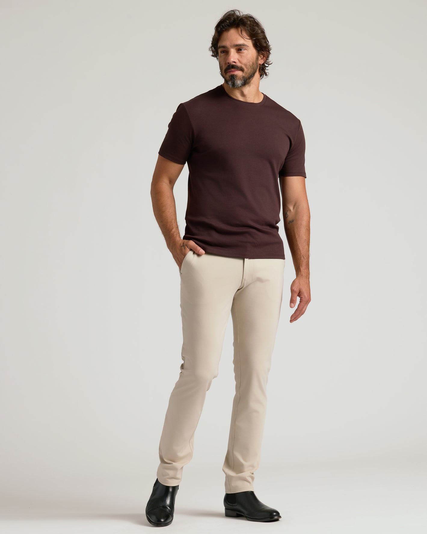 Model wearing Sandstone Commuter Pants with black Chelsea boots.