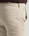Sandstone Commuter Pants showing back patch pocket and side-seam zipper.