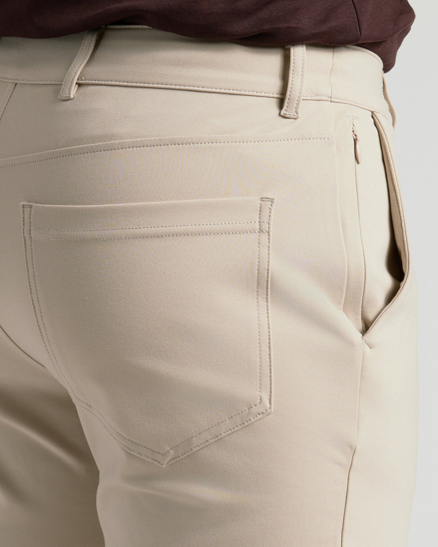 Sandstone Commuter Pants showing back patch pocket and side-seam zipper.
