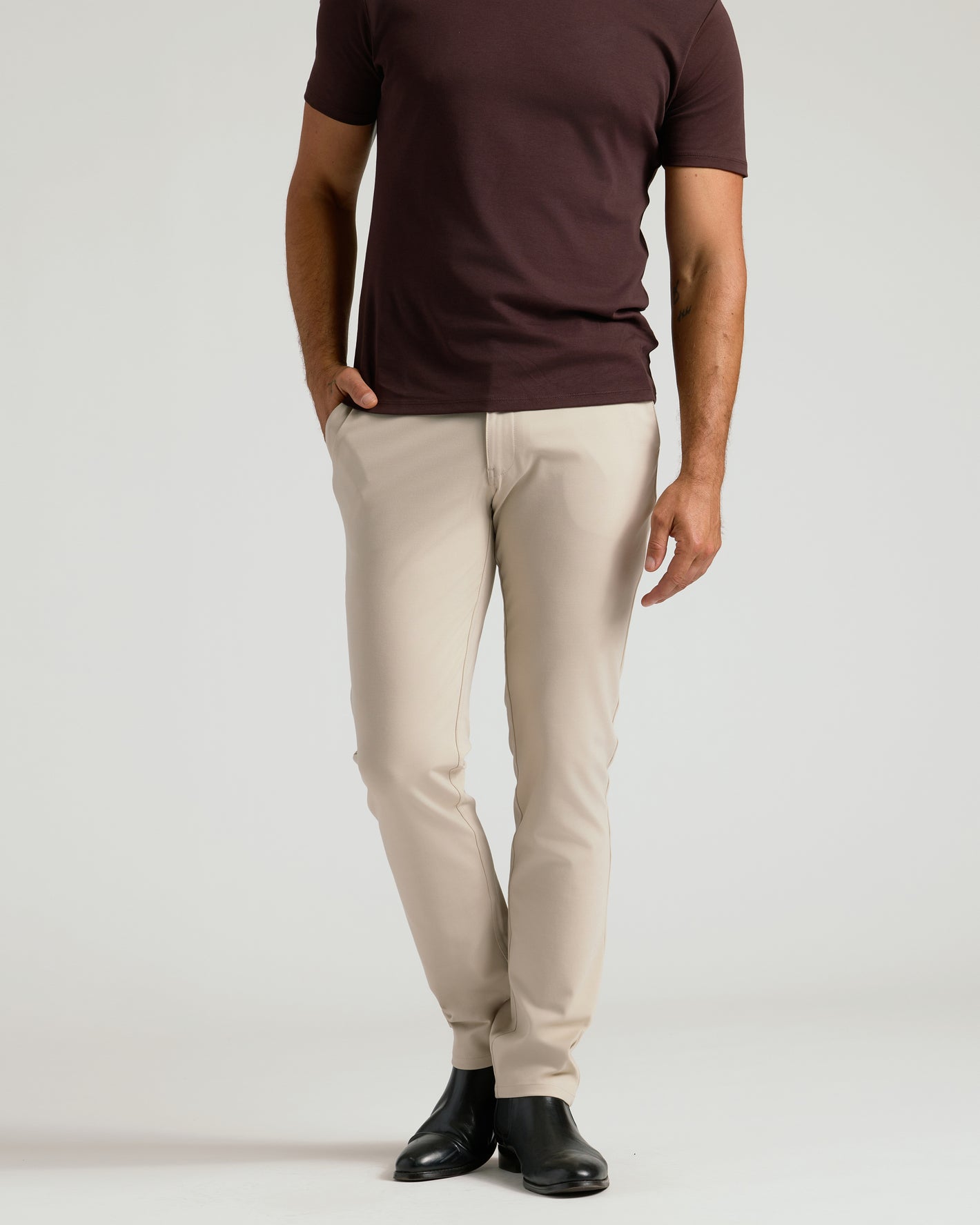 Sandstone Commuter Pants with slim fit, paired with black ankle boots.