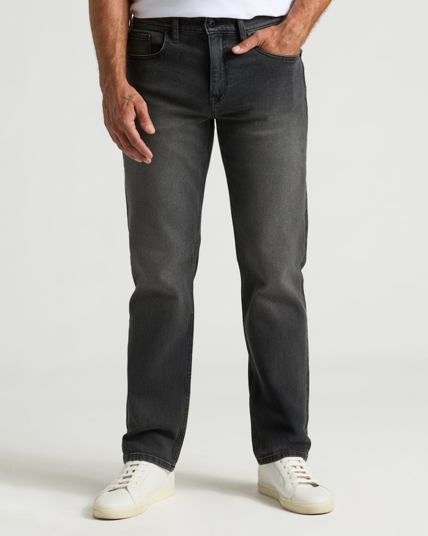 Gray Wash Straight Authentic Denim Jeans with white sneakers, hand in pocket.