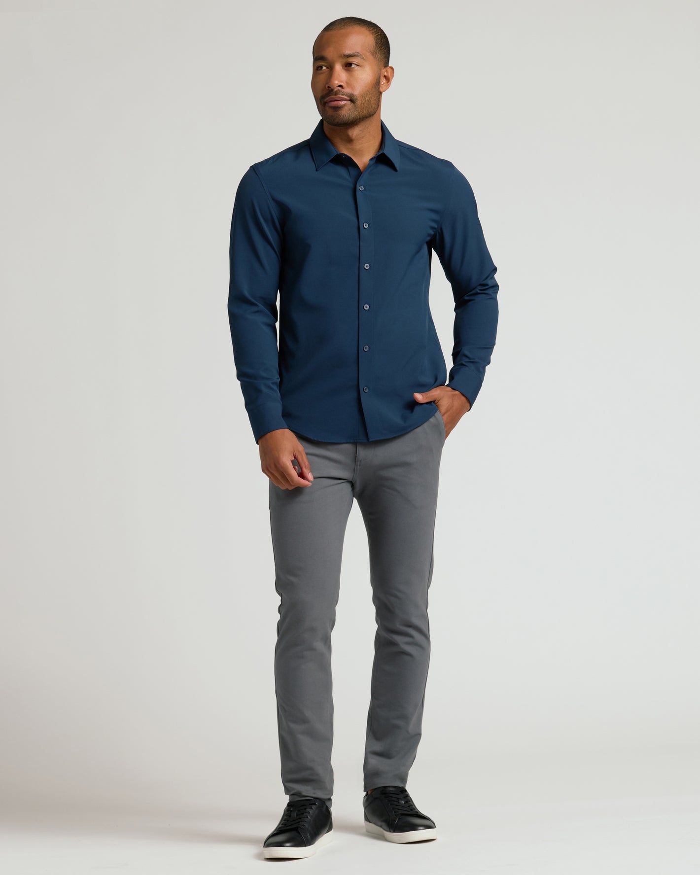 Man wears Navy & Carbon Slim Chino Pants, showcasing modern fit and style.