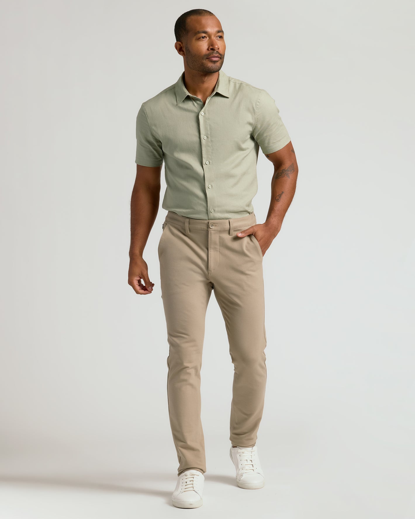 Model wearing Khaki Slim Chino Pants 2.0 with white sneakers.
