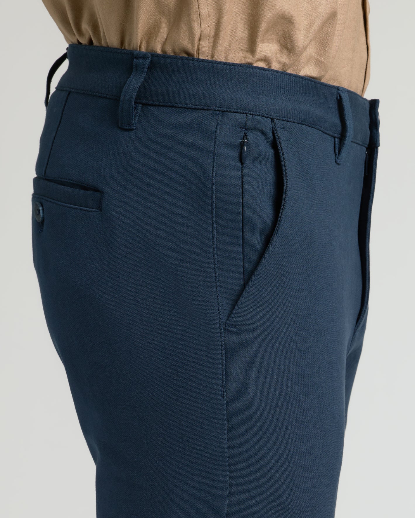 Navy Slim Chino Pants 2.0, showing waistband, pocket, and belt loops.