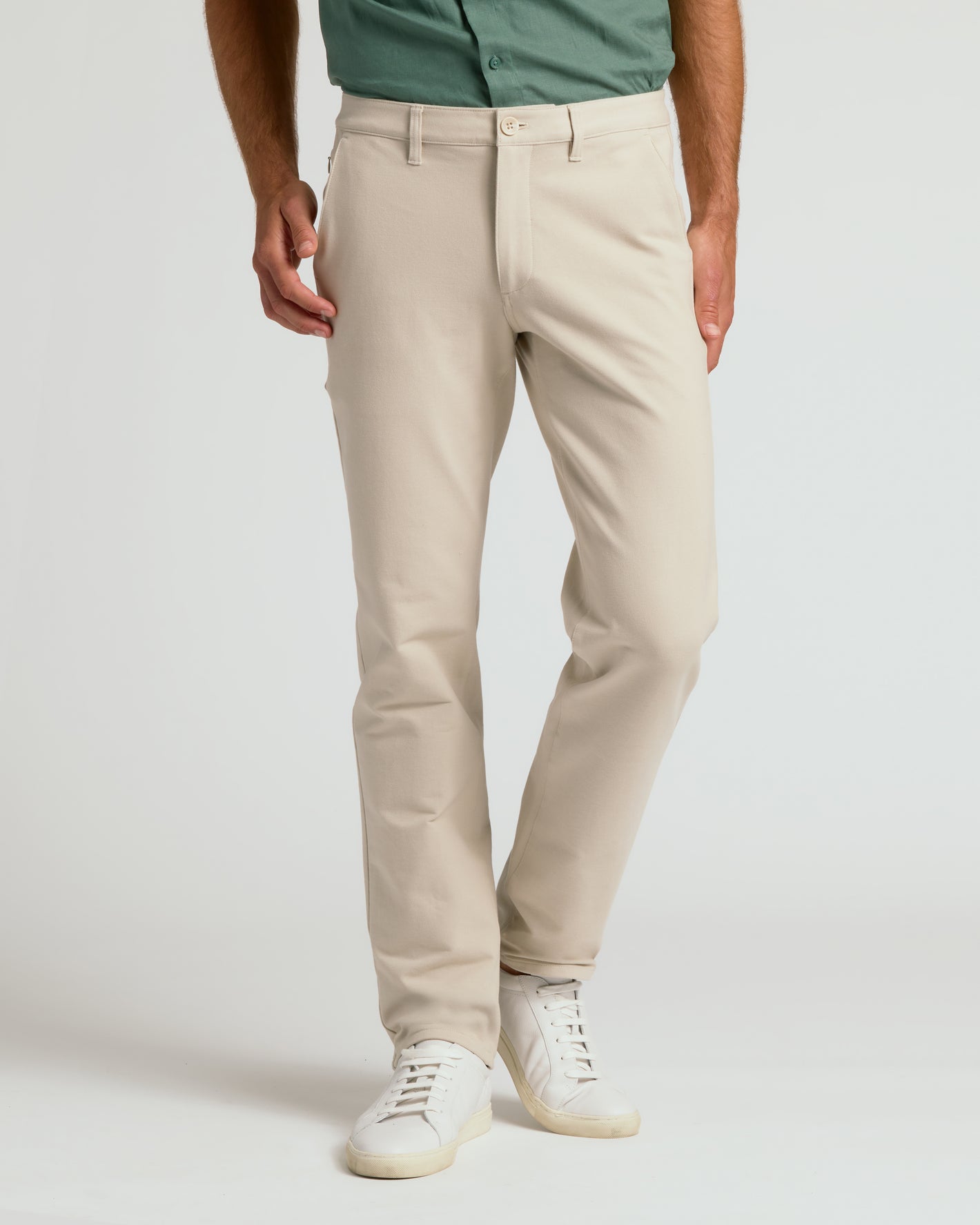 Sandstone Slim Chino Pants 2.0 with white sneakers.