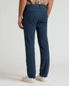 Navy Slim Chino Pants 2.0 back view, paired with white sneakers.
