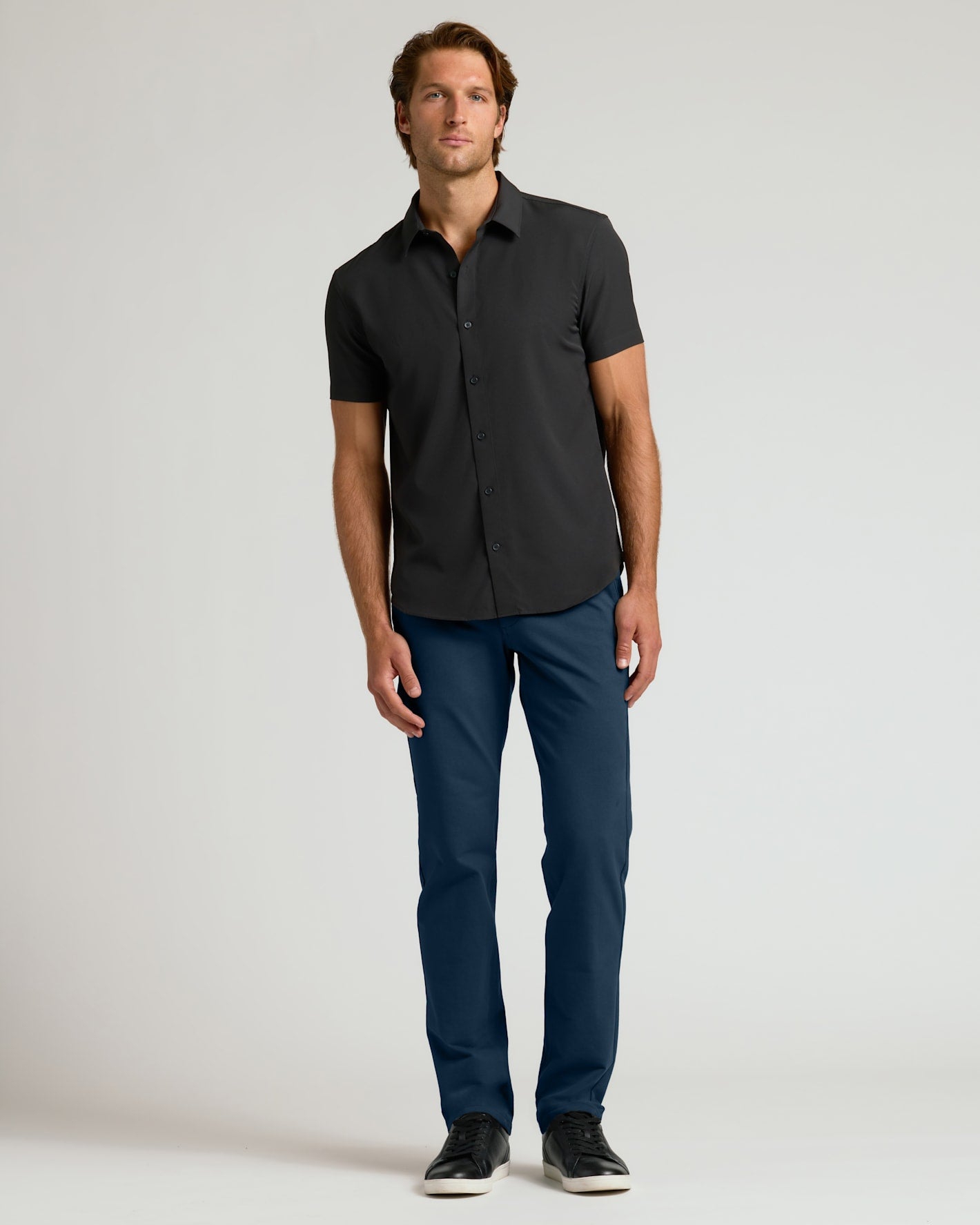 Man wearing Navy Straight Chino Pants 2.0 with black shirt.