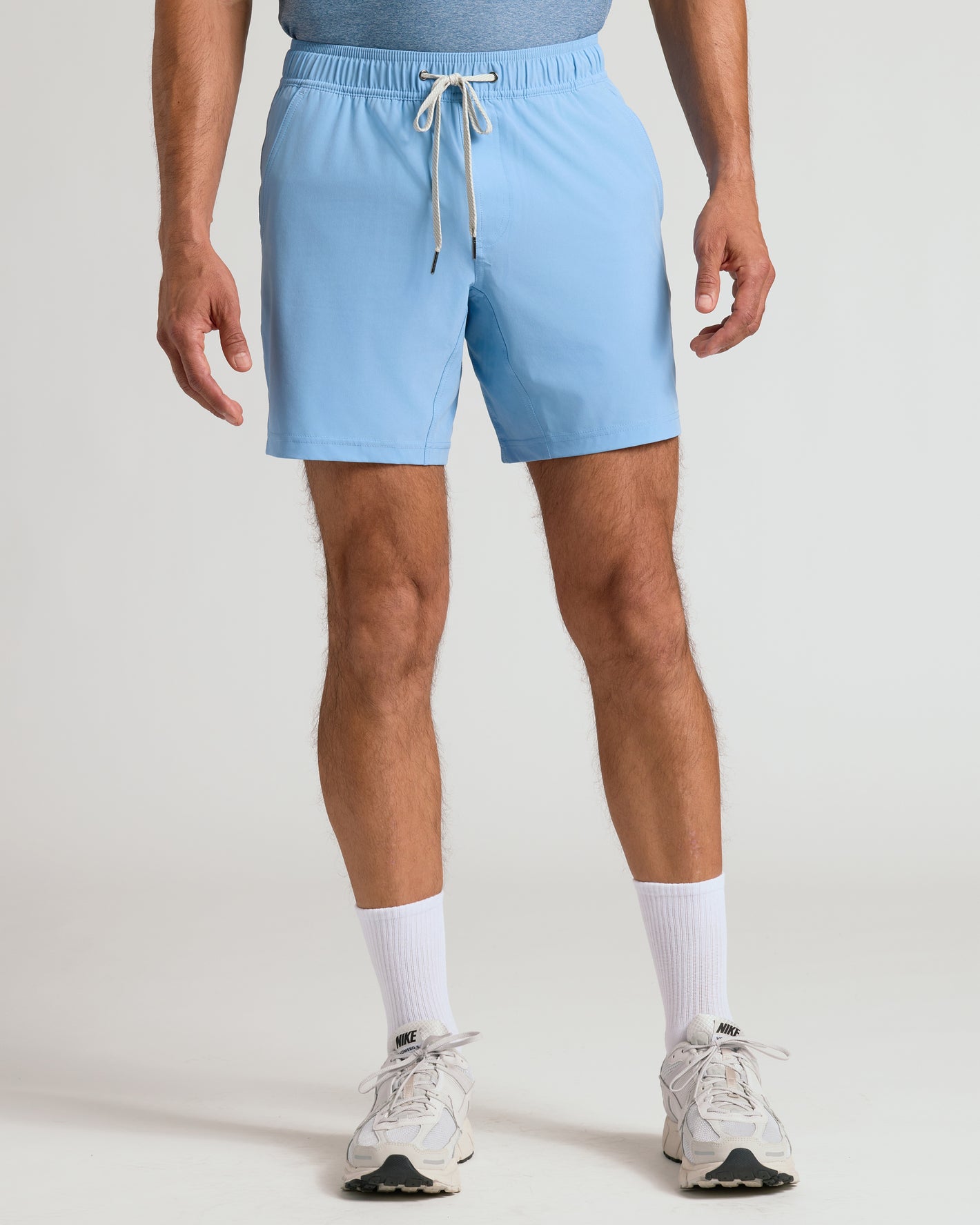 Man wearing Seasonal Active Quick Dry Short, white socks, and Nike shoes.