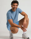 Man in Seasonal Active Quick Dry Short, smiling in athletic pose.