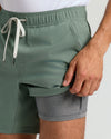 Person wearing Seasonal Active Quick Dry Short, showing sage-green outer and gray liner.
